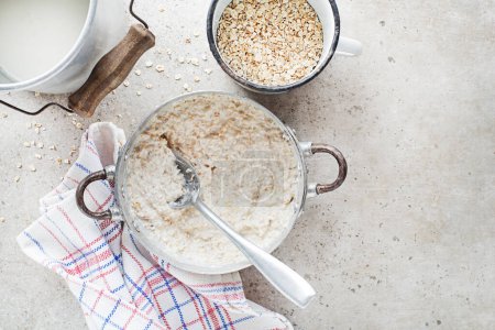 Photo for Oatmeal plate. Cooked oatmeal served with fresh milk. Healthy food, diet. Top view. - Royalty Free Image