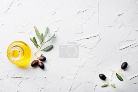 Photo for Olive oil in bottle with fresh olives fruit and olive branch on white background close up - Royalty Free Image