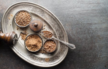 Photo for Organic Dried coriander seeds (Coriandrum sativum) and powder on rustic background. Healthy eating, Indian spice, flavoring, vitamin. - Royalty Free Image