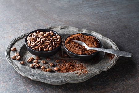 Photo for Coffee beans and freshly ground coffee powder on grey stone background close up - Royalty Free Image