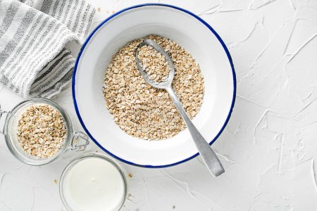 Photo for Oatmeal plate. Oatmeal served with fresh milk. Healthy food, diet. Top view. - Royalty Free Image