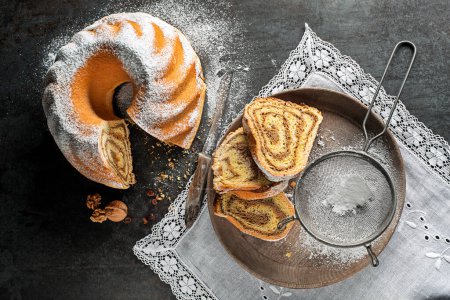 Foto de Potica, pastel de pan tradicional esloveno con nueces. Rollo de pan dulce relleno de nueces y espolvorear con azúcar - Imagen libre de derechos