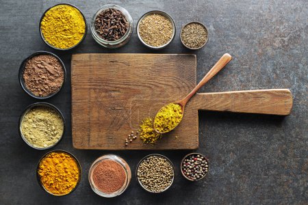 Photo for Colorful herbs and spices for cooking Indian dishes. Indian spices On grey stone background. Top view. - Royalty Free Image