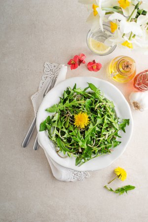 Photo for Fresh dandelion salad with dressing. Healthy spring food concept - Royalty Free Image