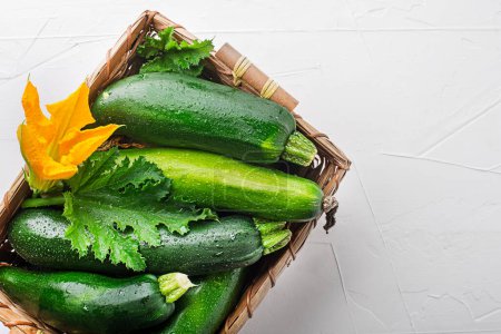 Photo for Basket of fresh vegetable crops with fresh zucchini on white background closeup - Royalty Free Image