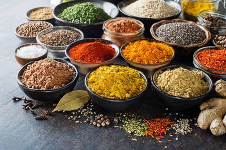 Photo for Colorful herbs and spices for cooking meal. Indian and Asian spices On grey stone background closeup - Royalty Free Image