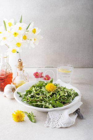 Photo for Fresh dandelion salad with dressing. Healthy spring food concept - Royalty Free Image