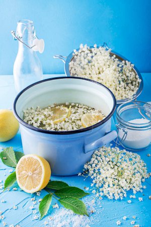 Photo for Process of making a summer drink, made from natural fermentation of elder flowers in water lemon and sugar. Preparation of an elder flower syrup from fresh elderflowers, honey and lemon - Royalty Free Image