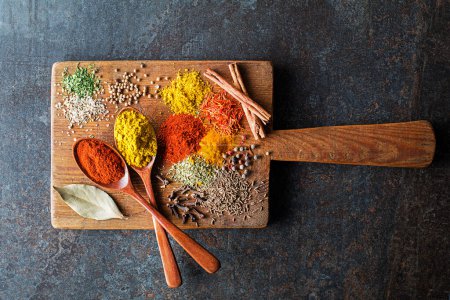 Photo for Colorful herbs and spices for cooking dishes. Indian and Asian spices On grey stone background closeup. - Royalty Free Image
