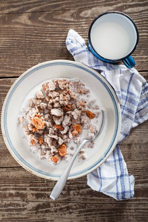 Photo for Slovenian traditional dish buckwheat mush served with pan-fried pork cracklings and lard, bowl warm milk close up shoot - Royalty Free Image