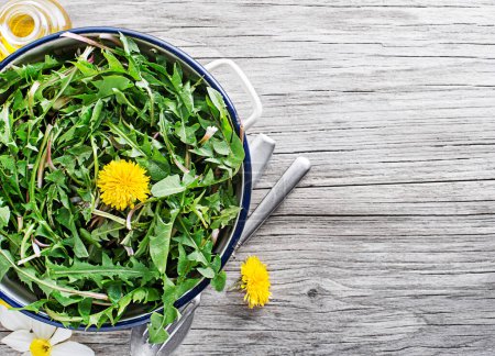 Photo for Fresh dandelion salad with dressing close up. Healthy spring food concept - Royalty Free Image