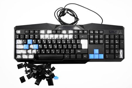 Photo for Broken keyboard. Destroyed keyboard. Black PC Keyboard is smashed and broken in half. PC repair shop cleans the keyboard from dus - Royalty Free Image