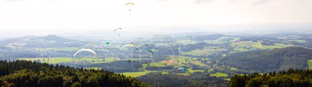 many paragliders in the air panorama