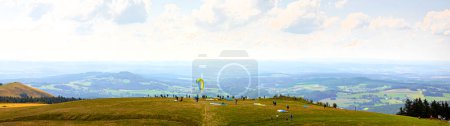 wasserkuppe, hesse, germany - 20 08 2023: paraglider and tourists on the famous german wasserkuppe panorama