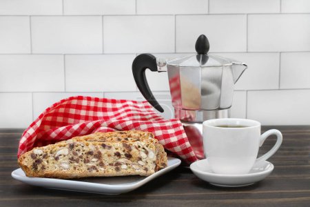 Photo for Almond, chocolate chip Italian biscotti, an espresso coffee pot and a cup of espresso. - Royalty Free Image