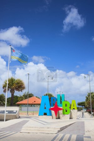 Photo for ORANJESTAD, ARUBA - JULY 17, 2022: Colorful Aruba sign with Aruba flag at Plaza Turismo at Surfside Beach in Oranjestad on the Caribbean island of Aruba (Selective Focus, Focus on the front of the image) - Royalty Free Image