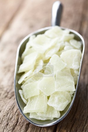 Photo for Candied or glace aloe vera gel slices in metal scoop on wood (Selective Focus, Focus one third into the image) - Royalty Free Image
