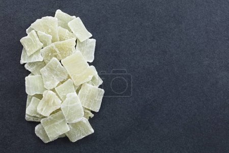Photo for Candied or crystallized aloe vera gel slices photographed overhead on slate with copy space on the side - Royalty Free Image