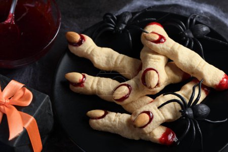 Creepy, scary Witch fingers made from sugar cookies with raspberry jam and almonds on Halloween. Trick-or-treat. Classic Cookie Witch Fingers takes on a healthy, gluten-free, paleo, vegan look.