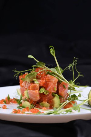 Photo for Avocado tartare with salmon, red caviar and pea sprouts. - Royalty Free Image