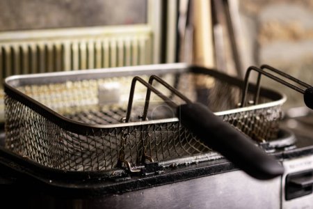 Photo for Empty dirty deep fryer basket. Preparation for cooking. - Royalty Free Image