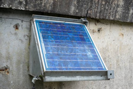 Photo for Stationary small solar panel on a concrete wall. - Royalty Free Image