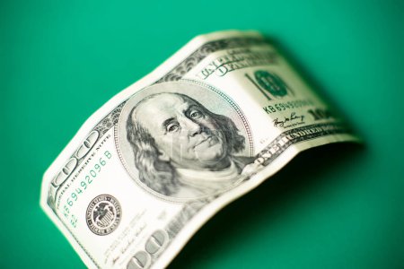 Photo for One hundred dollar bill on a green background. - Royalty Free Image