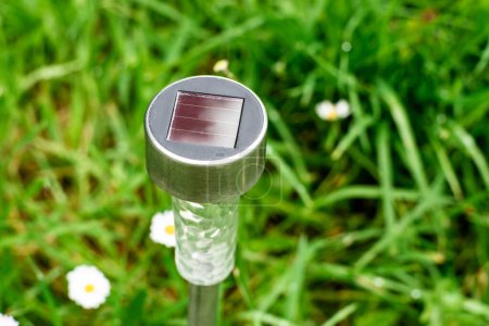 Téléchargez les photos : Lanterne de jardin solaire sur fond de feuillage vert. Énergie écologique, décor de jardin. - en image libre de droit