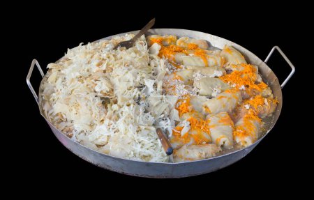 Fried cabbage and carrot  on  steel pan  isolated on  black