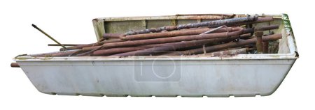 A farmer stores old rusty pipes in a broken boat. Isolated on white