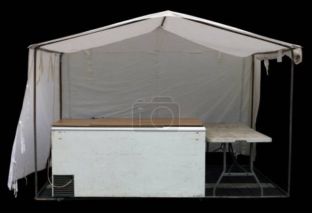 Photo for White canvas tent with  refrigerator on the street.  Isolated on black - Royalty Free Image