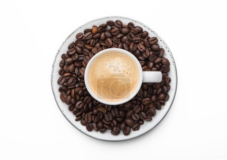 Foto de Espresso coffee in small cup and fresh raw beans on saucer on white background.Top view. - Imagen libre de derechos