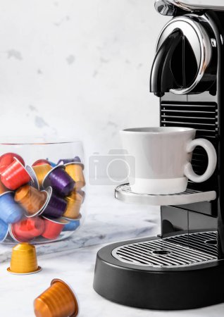 Photo for Preparation of fresh morning coffee from espresso machine with pods on white kitchen background. - Royalty Free Image
