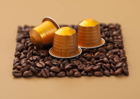 Photo for Coffee capsules suitable for machine on square coffee beans texture on beige - Royalty Free Image