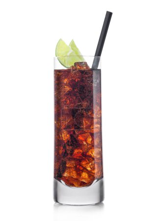Foto de Cuba Libre Cocktail in highball glass with ice cubes and slices of lime with black straw on white background. - Imagen libre de derechos