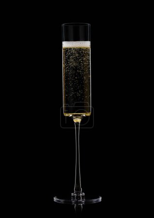Photo for Yellow golden champagne in fine crystal glass with bubbles on black - Royalty Free Image