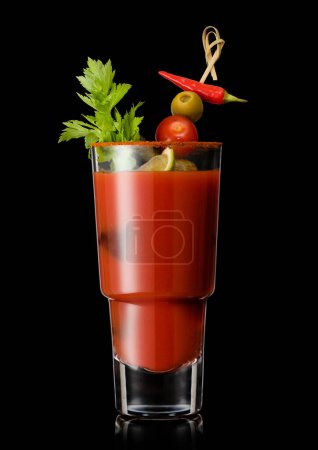 Photo for Glass of bloody mary cocktail with olive and celery and red paper on cocktail stick on black. - Royalty Free Image