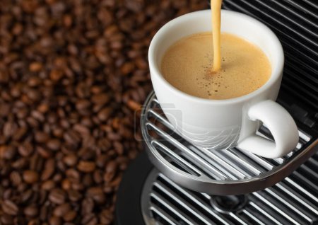 Photo for Pouring fresh morning coffee with espresso machine and sunlight and raw aroma beans.Macro - Royalty Free Image