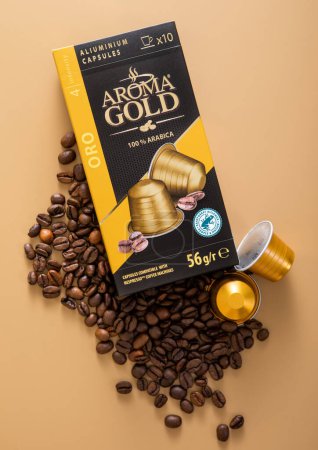 Photo for LONDON, UK - DECEMBER 20, 2022: Aroma Gold arabica aluminium capsules for coffee machine with raw beans.Top view - Royalty Free Image