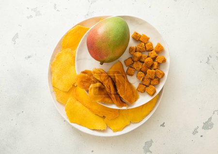 Photo for Plates with dried sweet mango slices and balls with fresh juicy mango. - Royalty Free Image