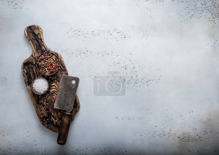 Photo for Meat cleaver on wooden cutting board with salt and pepper on kitchen background.Top view - Royalty Free Image