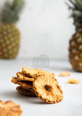 Photo for Organic sweet pineapple circle slices with ripe pineapple on light table. - Royalty Free Image