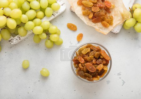 Photo for Green sweet dried raisins on light background with ripe grapes. - Royalty Free Image