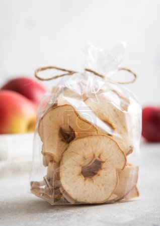Photo for Organic dried apple rings in clear package and red ripe apples in box. - Royalty Free Image