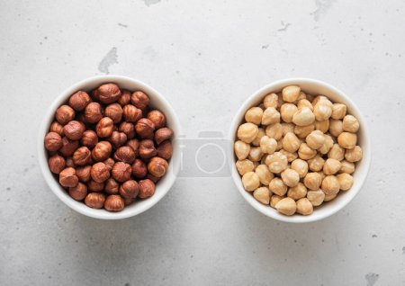Photo for Peeled and blanched healthy hazelnut nuts on light background. - Royalty Free Image