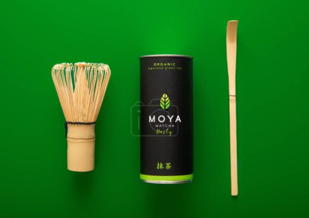 Photo for LONDON, UK - JANUARY 10, 2024: Moya organic green matcha tea with whisk and spoon on green. - Royalty Free Image
