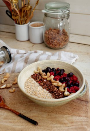 Foto de Desayuno saludable. harina de avena con bayas, granola y frutos secos - Imagen libre de derechos
