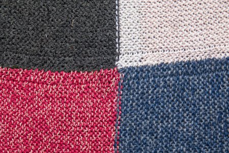 Photo for Traditional knitting background. Woolen knitted cloth of white, black, blue and red color - Royalty Free Image