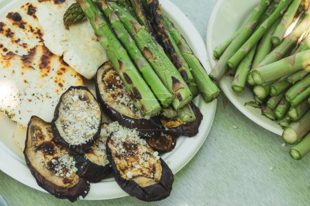 Photo for Delicious grilled vegetables on recycable white dishes. Grilled eggplant, asparagus, cheese. Summer barbeque - Royalty Free Image