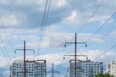 Photo for Electric power lines and roofs of multi apartment houses. Power supply in the city - Royalty Free Image